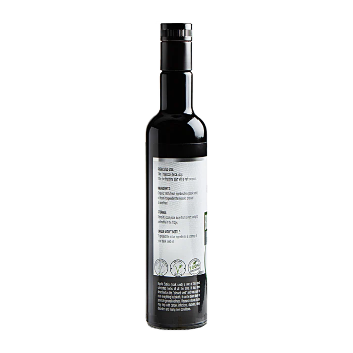 A dark glass bottle with a black cap and a white label displaying "Black Seed Oil Cold-Pressed Nigella Sativa," viewed from the back, available at Fisa Health.