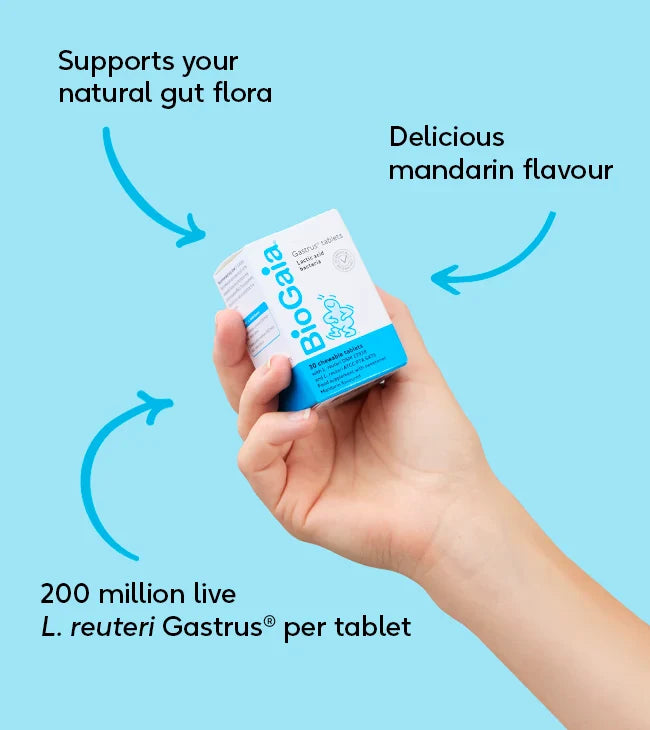 A hand holds a box labeled BioGaia Gastrus Tablets 30s with 200M L. reuteri Gastrus per tablet and mandarin flavor, available at Fisa Health.