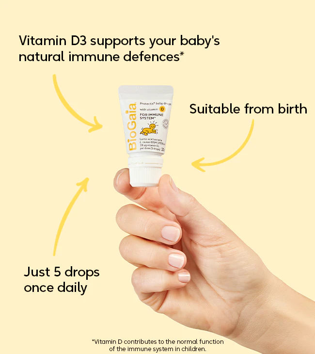 A hand holds BioGaia Protectis Baby Drops with Vitamin D 10ml. The packaging notes suitability from birth and a five-drop daily serving, available at Fisa Health.