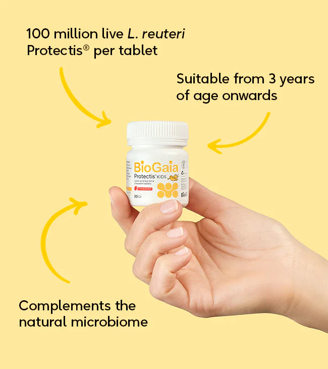 A hand holds a box of BioGaia Protectis Strawberry Kids Tablets 30s, featuring L. reuteri Protectis probiotics for children ages 3 and up, available at Fisa Health.
