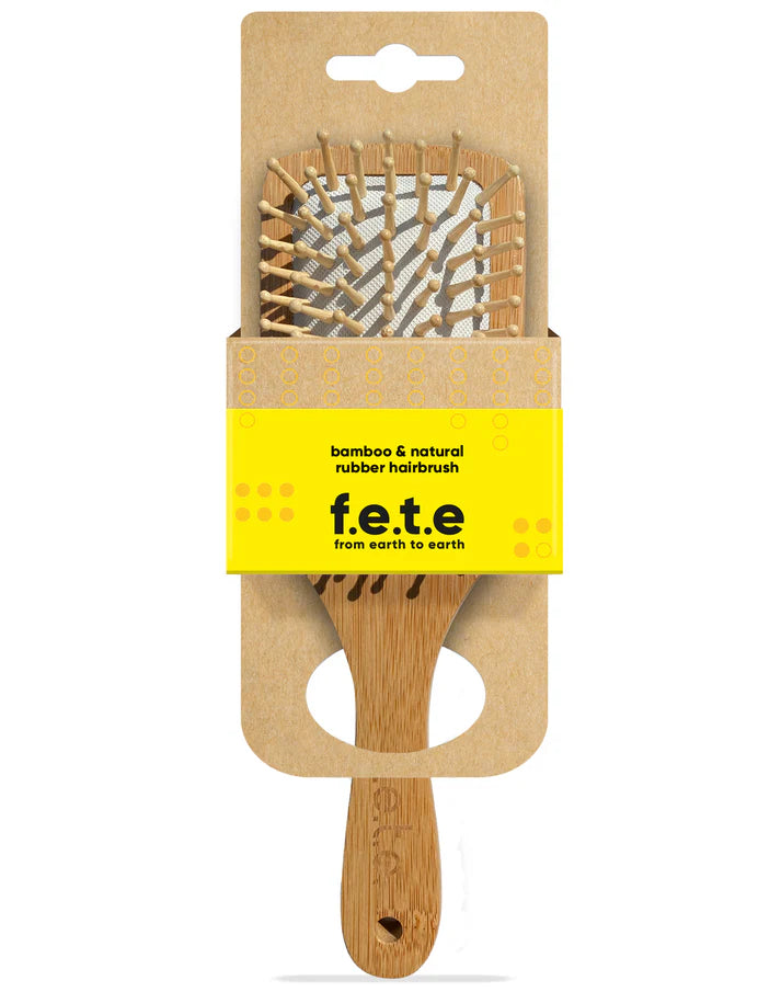 A F.E.T.E. Bamboo & Natural Rubber Hairbrush shown in eco-friendly cardboard packaging, available at Fisa Health.