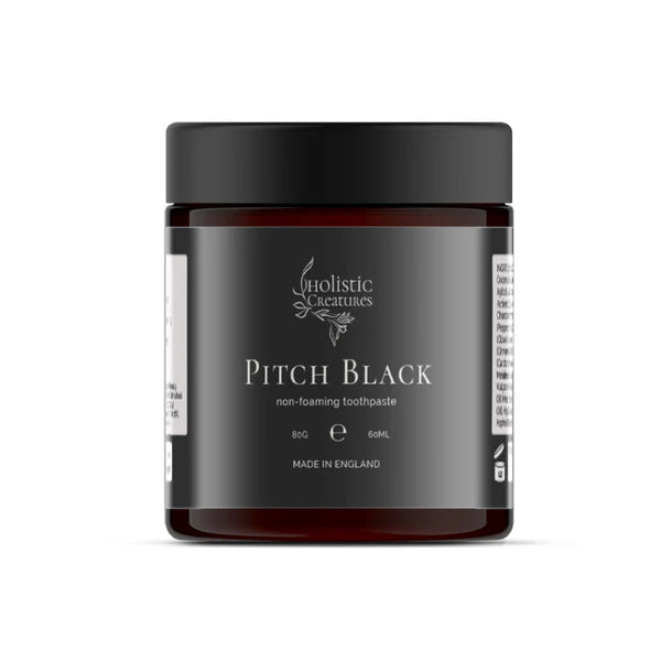 A brown jar with a black lid labeled Pitch Black Toothpaste, 60ml, made in England, available at Fisa Health.