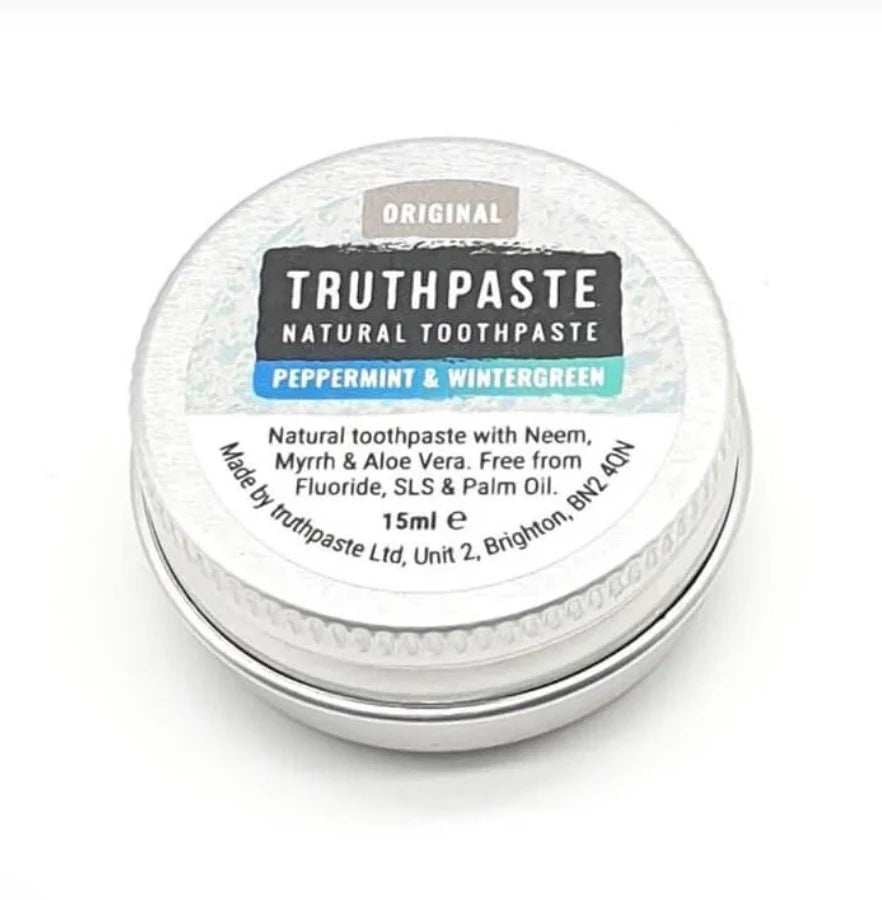 Truthpaste Adult’s Toothpaste, Peppermint & Wintergreen, 15ml tube. Fluoride, SLS, and palm oil free. Shown with natural ingredients. Made in Brighton, UK, available at Fisa Health.