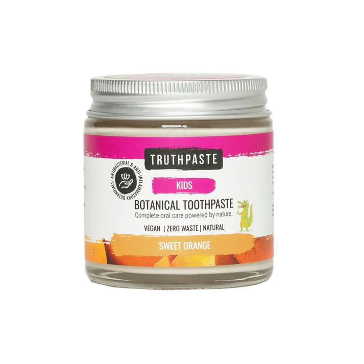 A glass jar of Truthpaste Children’s Truthpaste, Sweet Orange flavor, with a colorful label featuring a small cartoon dinosaur, available at Fisa Health.
