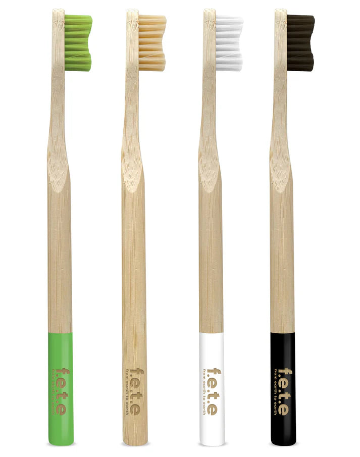 F.E.T.E. Multipack Firm Bamboo Toothbrushes (Pack of 4) displayed upright, each with a different colored handle and the label f.e.t.e. on the handle, available at Fisa Health.