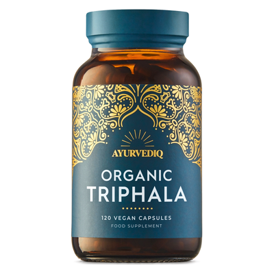 Amber glass bottle labeled Ayurvediq Organic Triphala 120 Vegan Capsules, with a gold pattern and blue label, displayed upright on a white background, available at Fisa Health.
