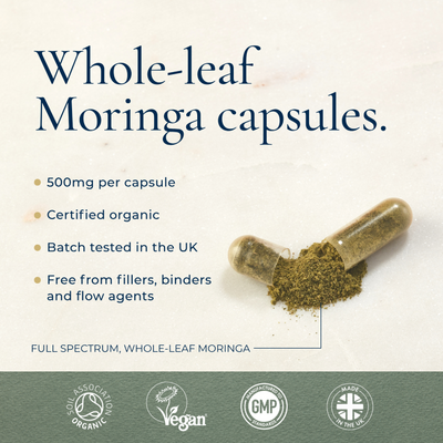 An open Ayurvediq Organic Moringa 120 Vegan Capsules bottle spills green powder. Text highlights its features and four certification icons appear below, available at Fisa Health.