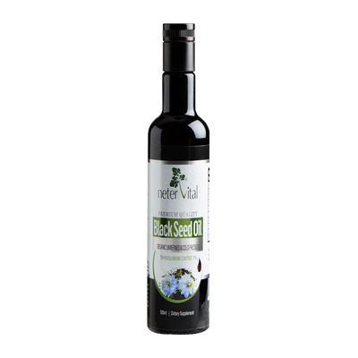 A dark glass bottle labeled Black Seed Oil Cold-Pressed Nigella Sativa with a black cap, shown next to Nigella Sativa seeds and flowers on a white background, available at Fisa Health.