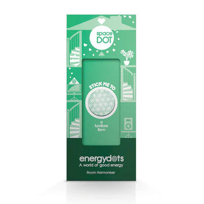 Green packaging for spaceDOT Room Harmoniser, featuring geometric patterns and house icons. Designed to be placed on furniture for decorative purposes, available at Fisa Health.