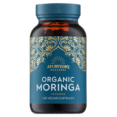 A brown bottle labeled Organic Moringa 120 Vegan Capsules features gold and blue decorative designs on the front, available at Fisa Health.