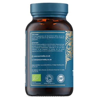 A brown bottle with a blue label for Organic Triphala 120 Vegan Capsules, showing usage instructions and other product details on the back, available at Fisa Health.