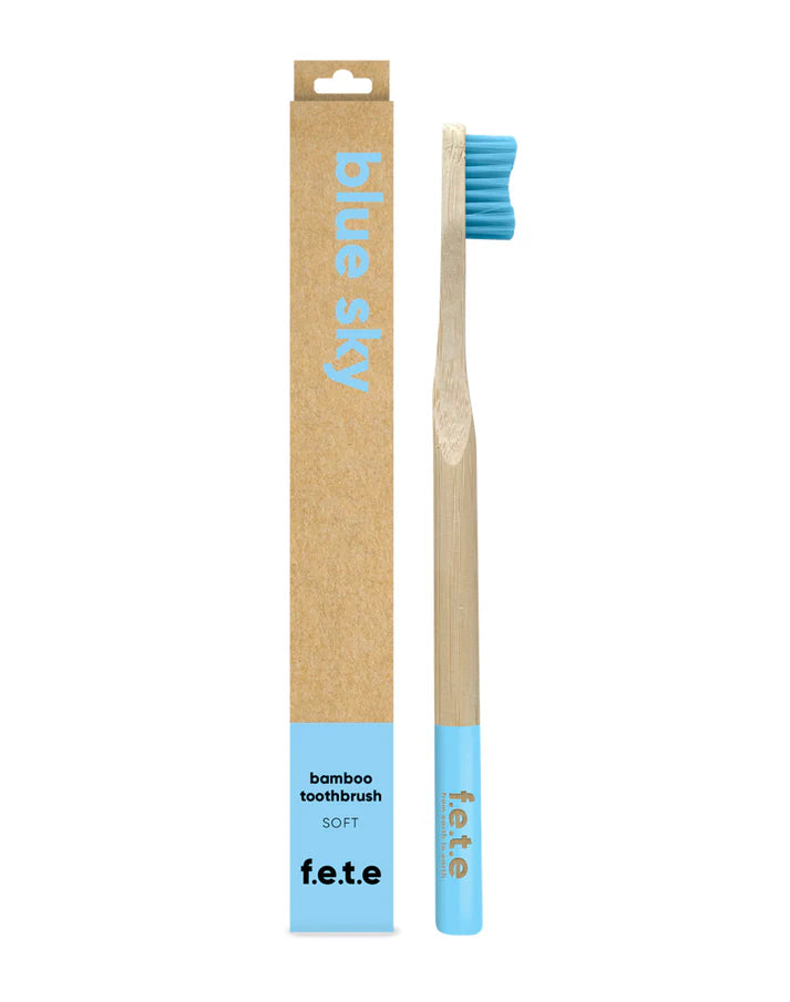 F.E.T.E. Single Soft Bamboo Toothbrush with blue bristles, a biodegradable handle, and eco-friendly Blue Sky packaging, available at Fisa Health.