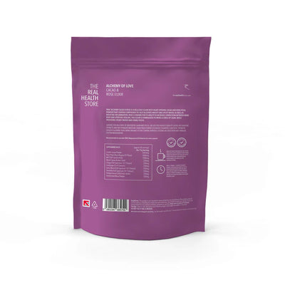 Purple resealable pouch labeled Alchemy Cacao & Rose Elixir - 330 grams, showing Criollo cacao, edible rose petal powder, and nutrition facts on the back, available at Fisa Health.