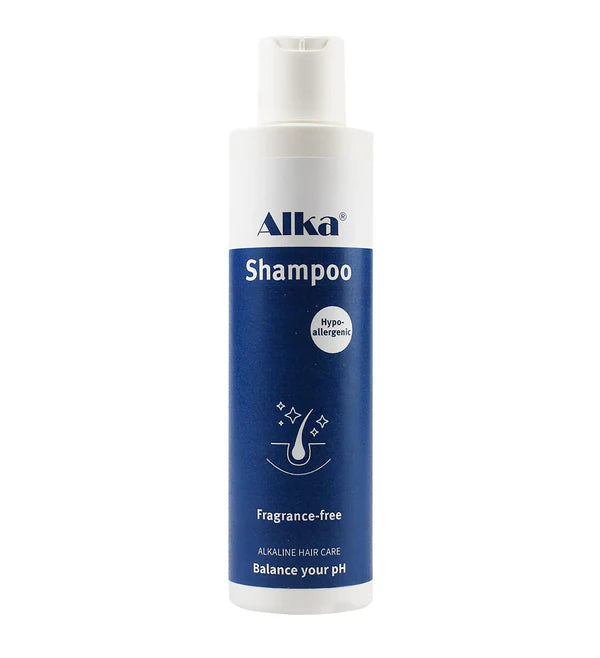 A white and blue Alka® Shampoo bottle for sensitive scalp, labeled fragrance-free, hypo-allergenic, pH balanced, with a flip-top cap and minimal design, available at Fisa Health.