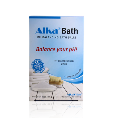 A blue and white box labeled Alka® Bath alkaline bath salt, showing pH balance details and illustrations of bath accessories, available at Fisa Health.