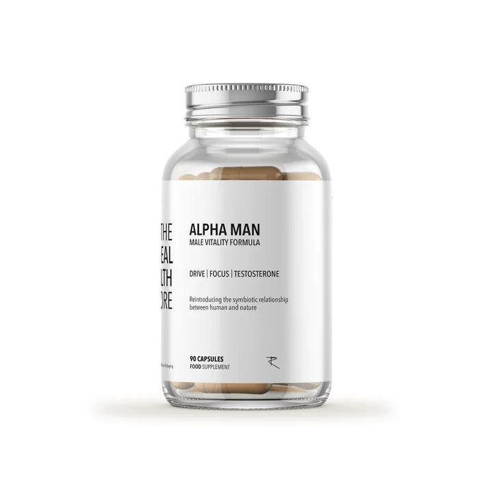 A clear bottle labeled Alpha Man (Multi Mineral, Testosterone & Libido Boosting) (90 Caps) contains beige capsules. The label features the words drive, focus, and testosterone support, available at Fisa Health.