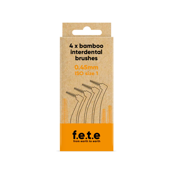 A cardboard box labeled "F.E.T.E. Bamboo Interdental Brushes, 0.45mm ISO size 1" displays line art of bamboo brushes on eco-friendly packaging, available at Fisa Health.