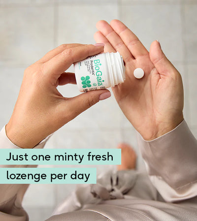 A person pours a BioGaia Prodentis Lozenges 30s tablet into their hand. The packaging shows the BioGaia brand name and product details. Available at Fisa Health.