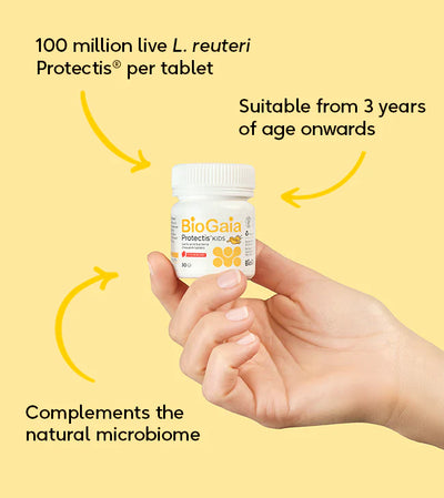 A hand holds a box of BioGaia Protectis Strawberry Kids Tablets 30s, featuring L. reuteri Protectis probiotics for children ages 3 and up, available at Fisa Health.
