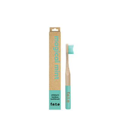 F.E.T.E. Children’s Bamboo Toothbrush with a mint green handle and bristles, shown alongside its brown and mint green "Magical Mint" box, available at Fisa Health.