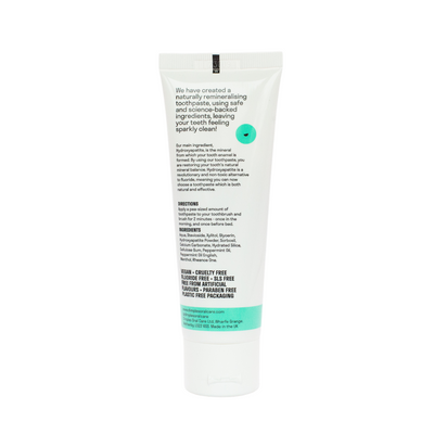 A white tube labeled Dimples Hydroxyapatite Toothpaste with black text and a green label near the bottom displaying vegan and cruelty-free icons, available at Fisa Health.