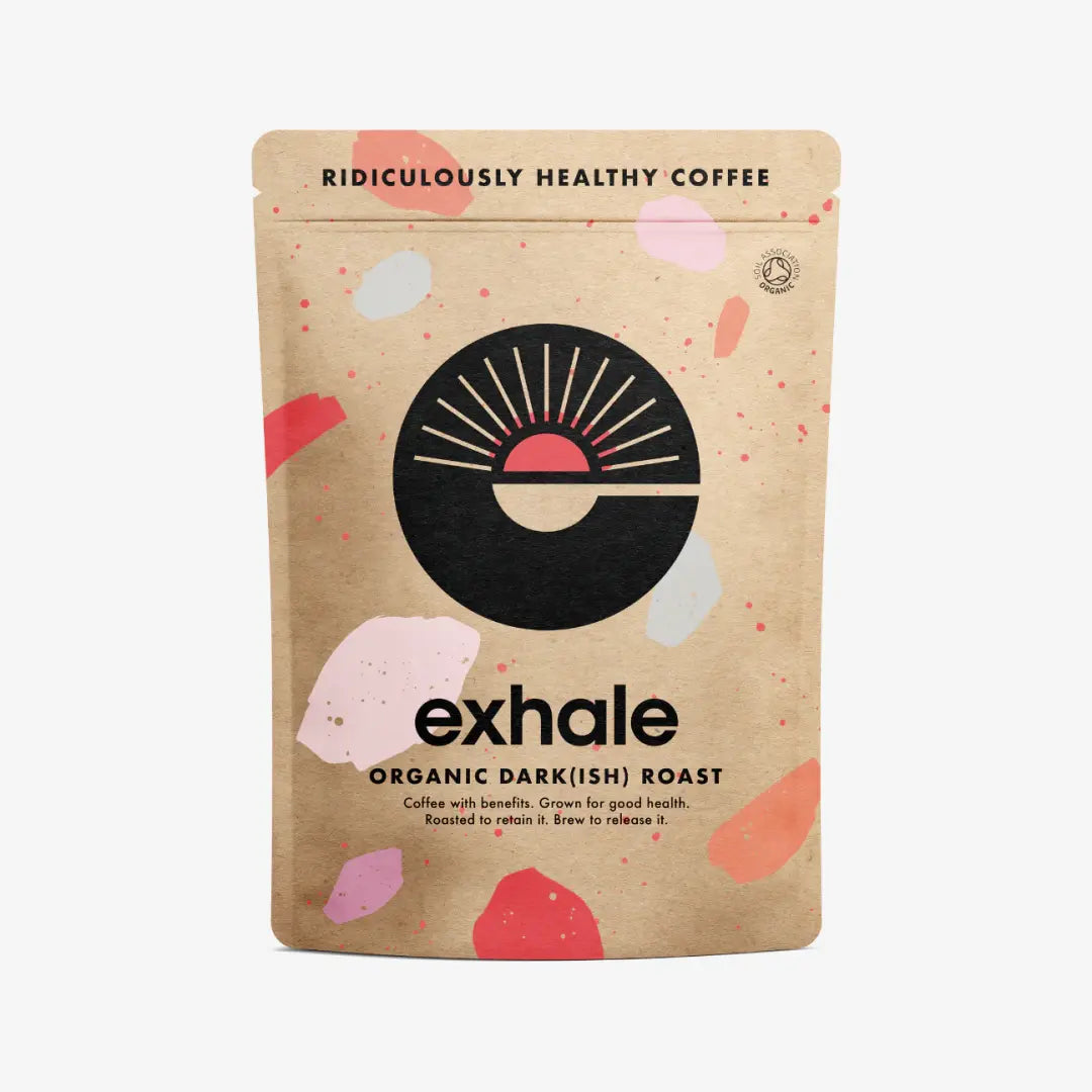 A brown Exhale Coffee - Dark(ish) - Ground bag featuring a bold sun design, colorful shapes, and the label “Ridiculously Healthy organic coffee”, available at Fisa Health.