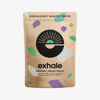 A brown Exhale Coffee House Wholebean bag features a black and green logo, abstract shapes, and product text. Available at Fisa Health.
