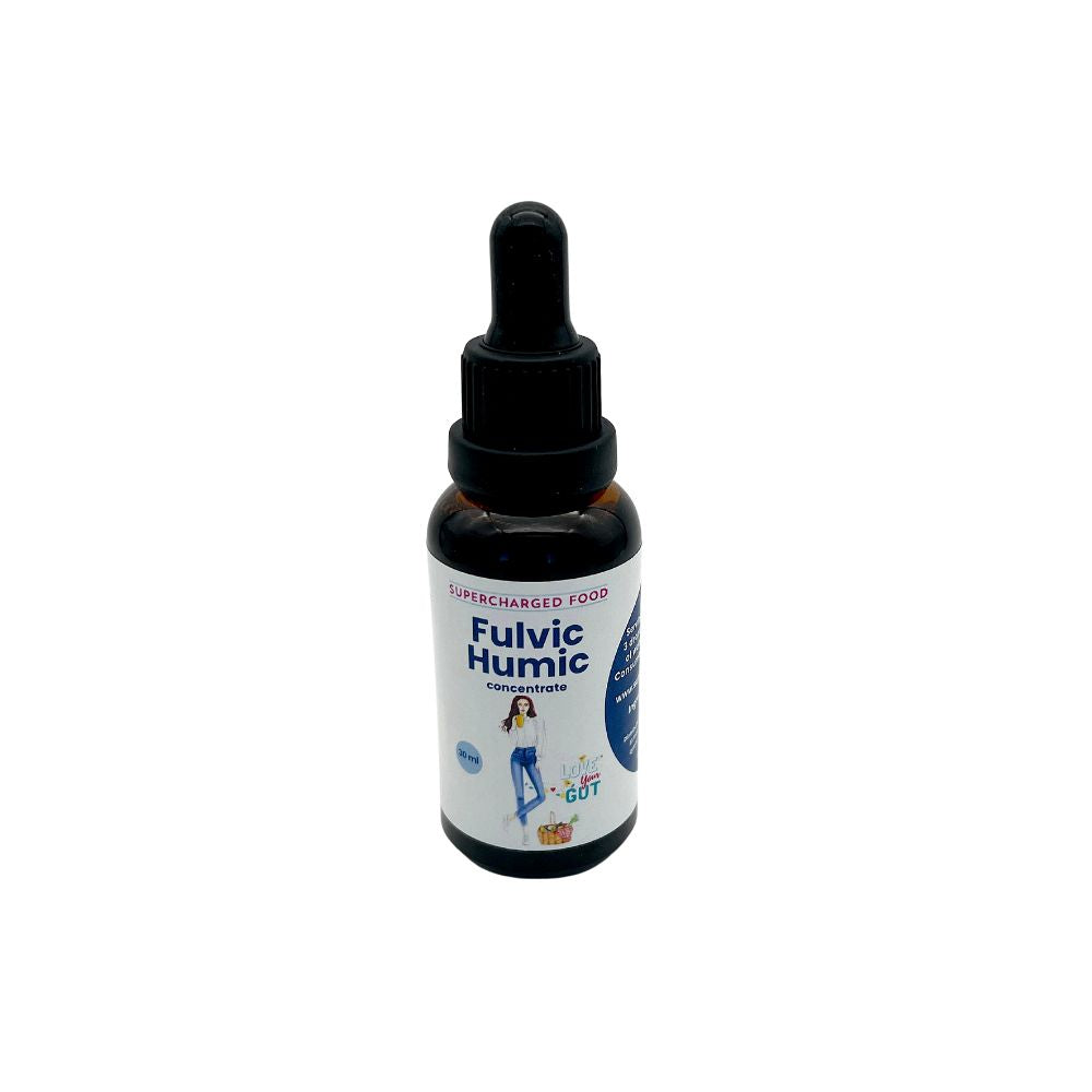 A dropper bottle labeled Love Your Gut Fulvic Humic Concentrate drops by Supercharge Your Gut, featuring a cartoon and "Vegan Gut Cleanse" text on the front, available at Fisa Health.