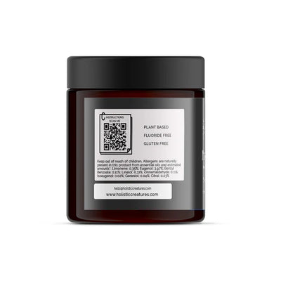 A dark amber jar with a black lid features a white label showing a QR code, Pitch Black Toothpaste - 60ml, plant based, fluoride and gluten free. Website and cautions are below; available at Fisa Health.