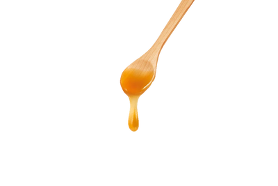Honestly Manuka Premium Raw Manuka Honey 350+ dripping from a wooden spoon, available at Fisa Health.