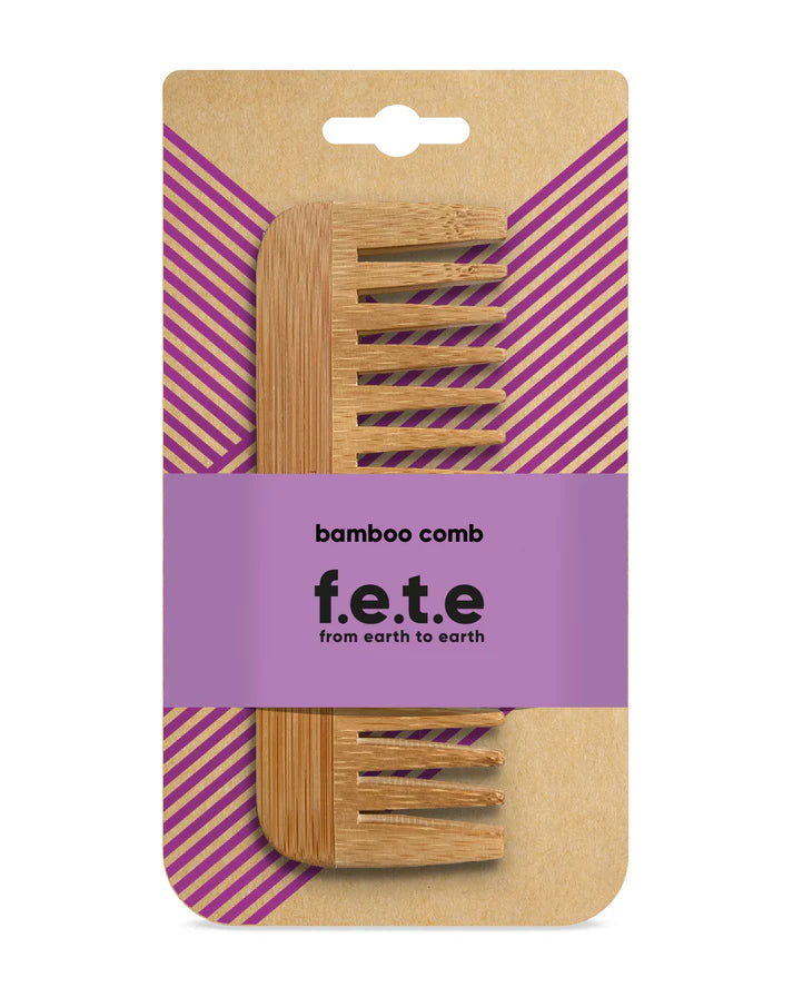 The F.E.T.E. Natural Bamboo Comb is shown in purple-striped packaging and is noted for being biodegradable and eco-friendly, available at Fisa Health.