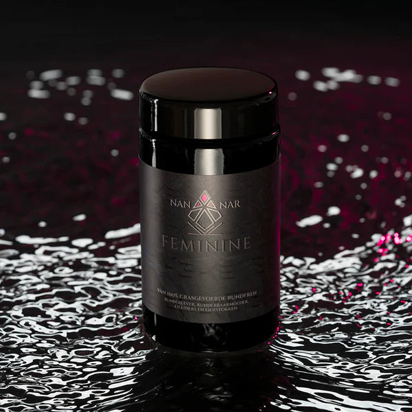 A black jar labeled Nannar Feminine is displayed on a reflective surface with water ripples, available at Fisa Health.