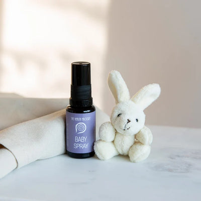 A 15ml Nano Zinc Baby Spray by The Health Factory is placed beside a white plush bunny on a light surface with a neutral background, available at Fisa Health.