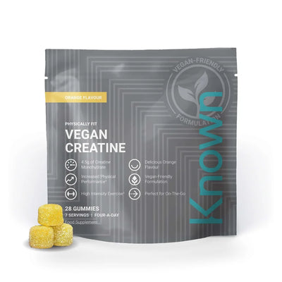A grey pouch of Known Nutrition Vegan Creatine Gummies, 28 pack, featuring orange flavor text with three yellow sugar-coated supplements in front, available at Fisa Health.