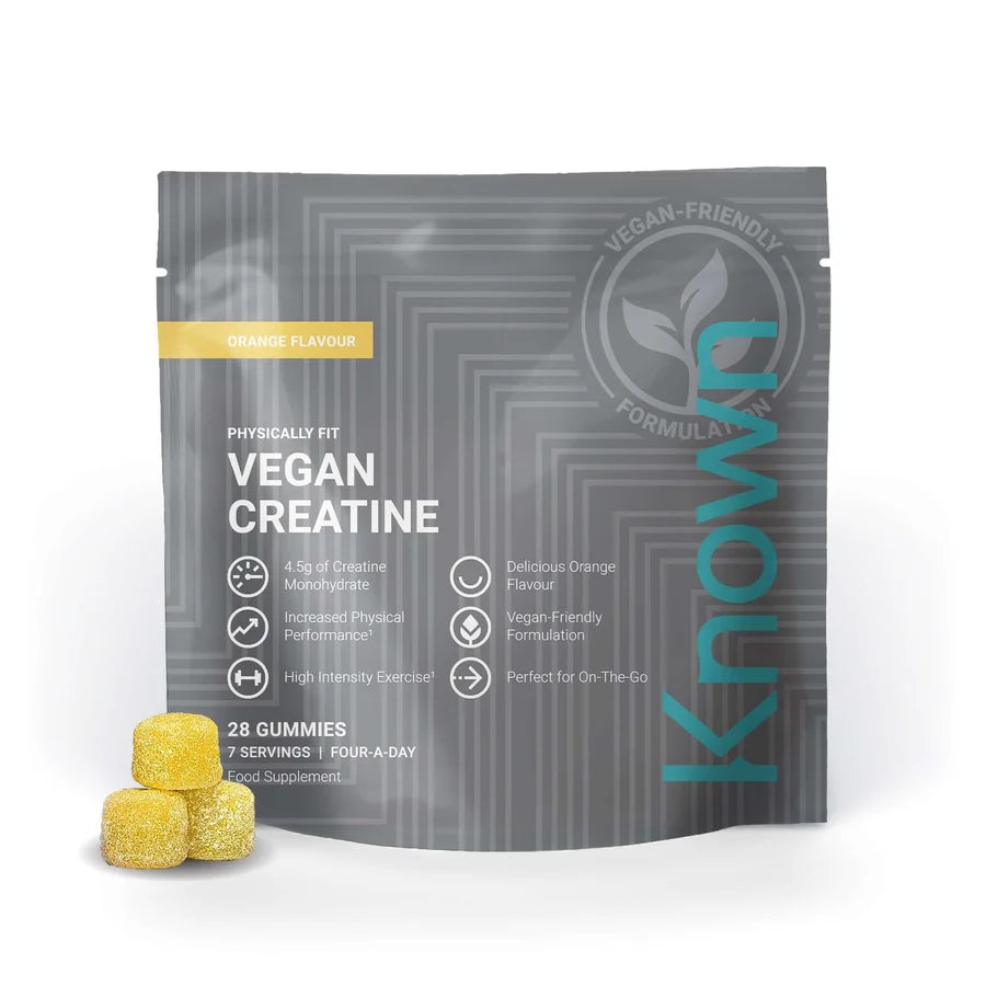 A grey pouch of Known Nutrition Vegan Creatine Gummies, 28 pack, featuring orange flavor text with three yellow sugar-coated supplements in front, available at Fisa Health.