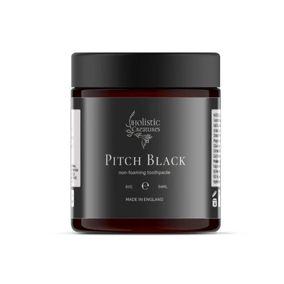 A brown jar with a black lid labeled Pitch Black Toothpaste, 60ml, made in England, available at Fisa Health.