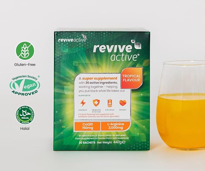 A box of Revive Active Tropical Multi-Nutrient Sachets is next to a glass of orange drink. Packaging notes vegan, gluten-free, halal, with CoQ10. Available at Fisa Health.