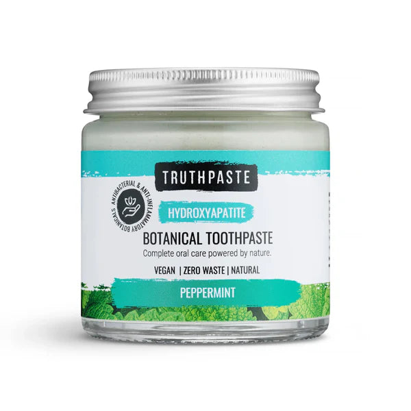 A jar of Truthpaste Hydroxyapatite Toothpaste (Peppermint), vegan, zero waste, natural, with a silver lid and green leafy design, available at Fisa Health.