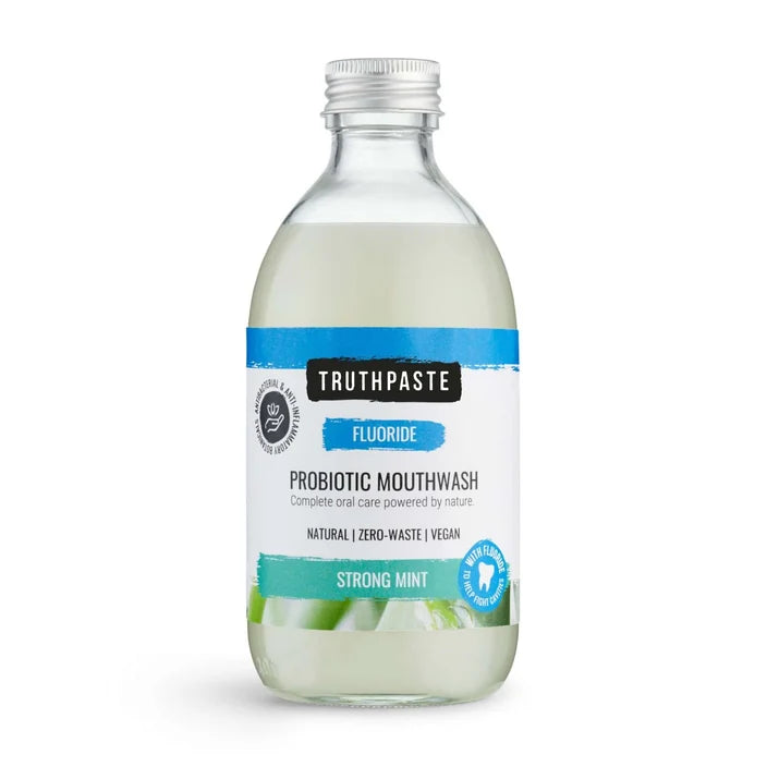 Small glass bottle of Truthpaste Strong Mint Probiotic Mouthwash 30ml with a silver cap and a blue and white label featuring peppermint, available at Fisa Health.