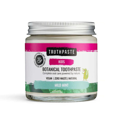 A glass jar of Truthpaste Children’s Truthpaste, a vegan xylitol toothpaste with colorful labeling and a green dinosaur illustration, available at Fisa Health.