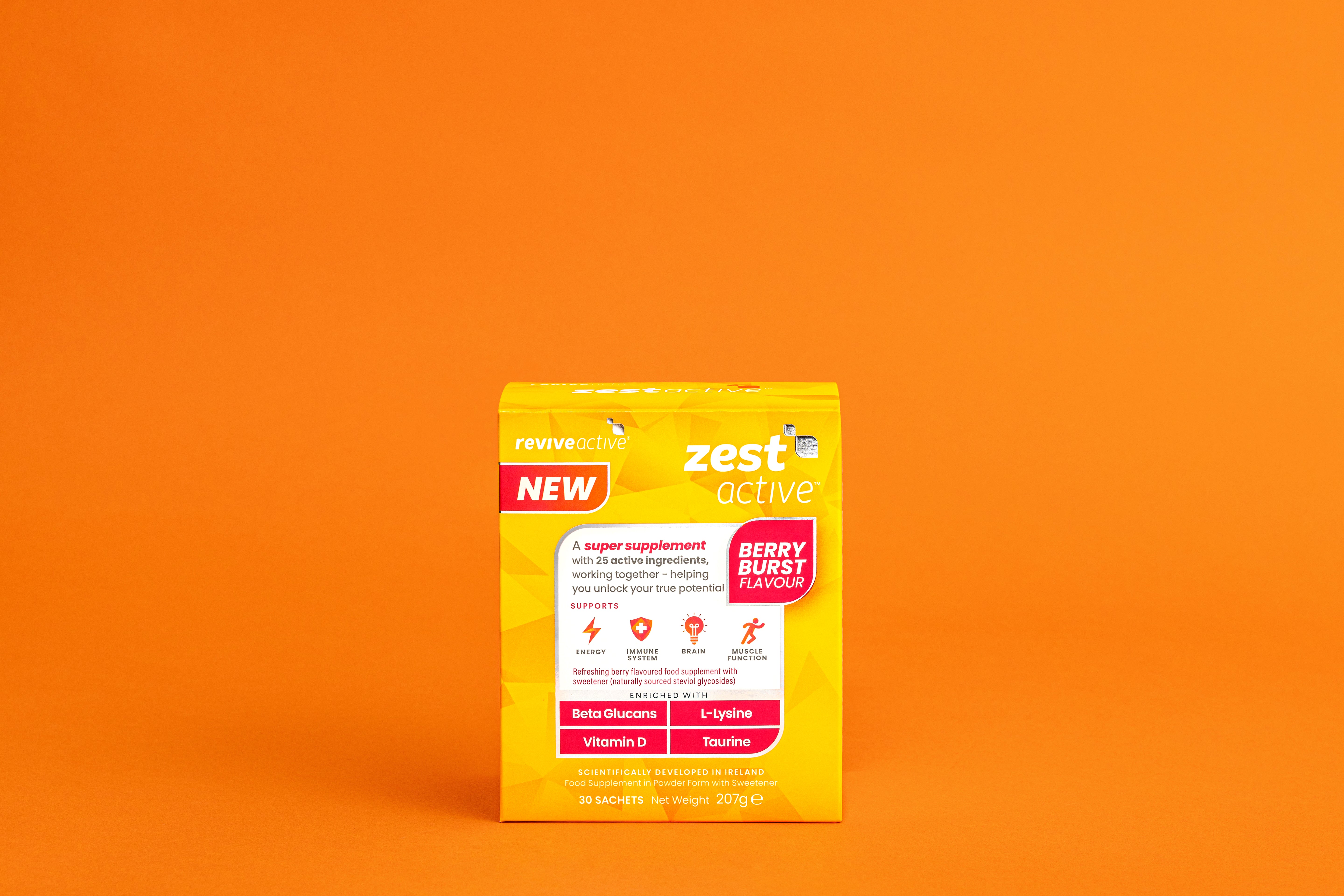A yellow box of Revive Zest Active- Berry Burst is displayed against an orange background, available at Fisa Health.