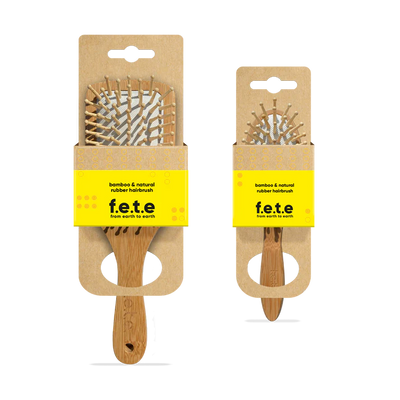Two F.E.T.E. Bamboo & Natural Rubber Hairbrushes, one large and one small, displayed in eco-friendly cardboard packaging, available at Fisa Health.