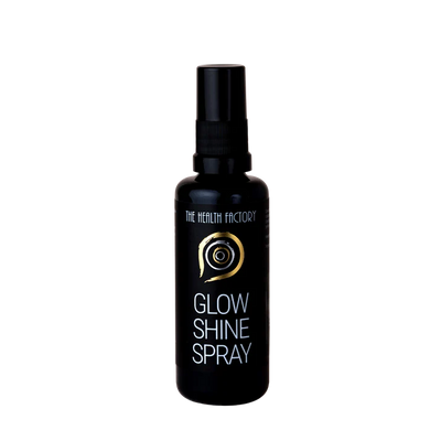 A black spray bottle labeled Glow & Shine Spray with a gold swirl design and the phrase "pure gold" on the front, available at Fisa Health.