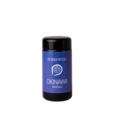 A blue cylindrical container with a black cap labeled Okinawa Sea Coral Minerals calcium magnesium supplement, set on a plain white background; available at Fisa Health.